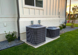 Double outdoor AC units, each clean and well-maintained with fresh grass surrounding them