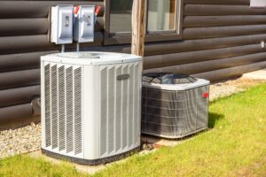 two outdoor air conditioning units sitting next to each other