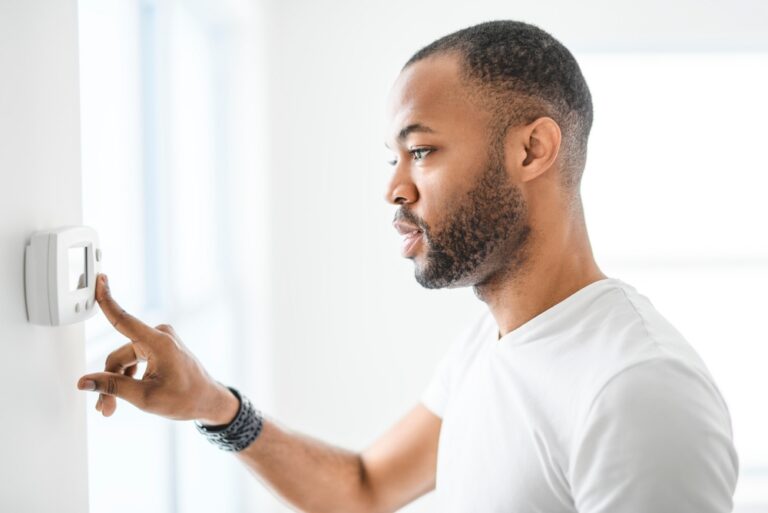A,Man,Choosing,Temperature,On,Thermostat.,Young,Focused,Guy,Pushing